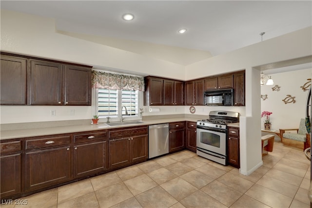 kitchen with light tile patterned floors, a sink, appliances with stainless steel finishes, light countertops, and dark brown cabinetry