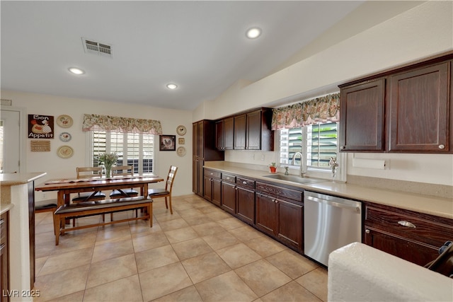 kitchen featuring light countertops, stainless steel dishwasher, and a sink