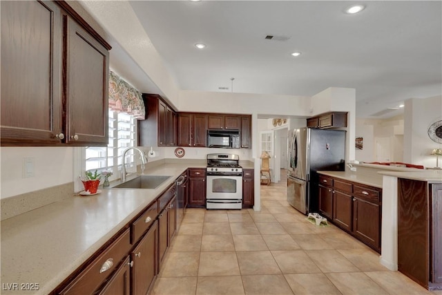 kitchen featuring light tile patterned floors, stainless steel appliances, light countertops, a sink, and visible vents