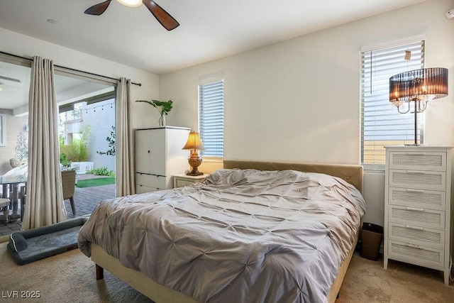 carpeted bedroom featuring access to outside and multiple windows