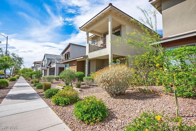 view of property exterior with stucco siding and a balcony