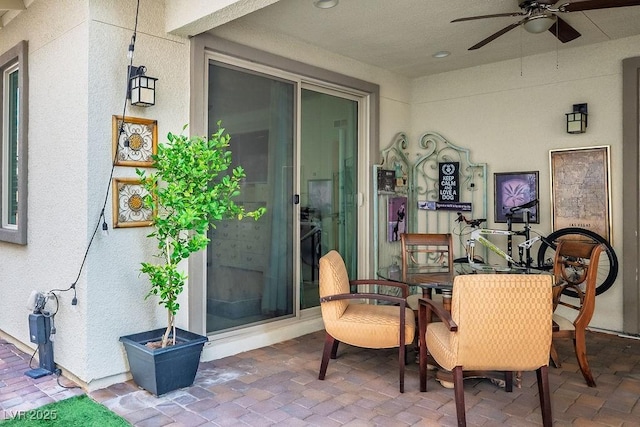 exterior space featuring ceiling fan