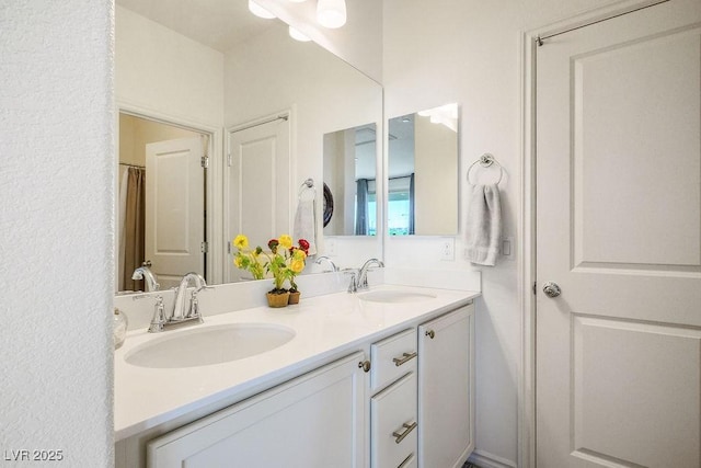 bathroom featuring double vanity and a sink