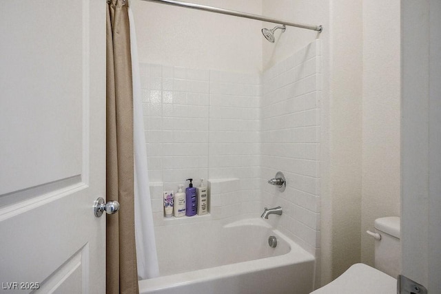 bathroom featuring shower / tub combo and toilet