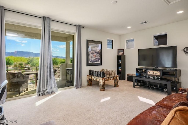 living room with a mountain view, visible vents, recessed lighting, and carpet floors
