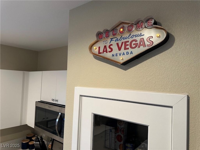 11257 Rainbow Peak Ave Unit 201, Las Vegas, NV 89135 - interior details featuring stainless steel microwave and white cabinets