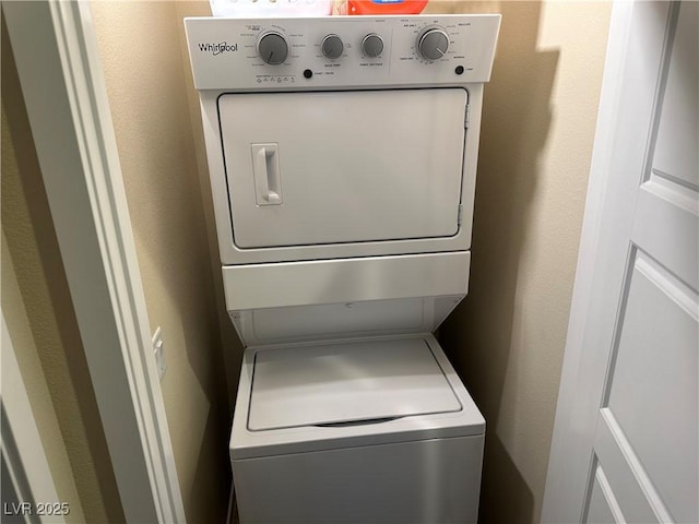 11257 Rainbow Peak Ave Unit 201, Las Vegas, NV 89135 - laundry room with stacked washing maching and dryer, laundry area, and a textured wall
