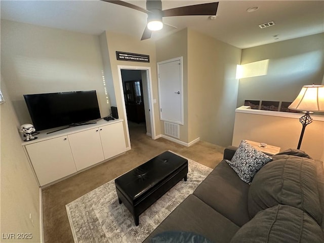 11257 Rainbow Peak Ave Unit 201, Las Vegas, NV 89135 - living area featuring visible vents, ceiling fan, baseboards, and light carpet