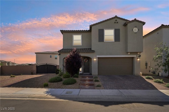 4630 Adonis Blue St, North Las Vegas, NV 89031 - mediterranean / spanish house with a tile roof, a gate, stucco siding, driveway, and an attached garage