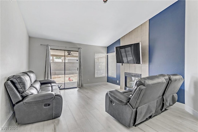 5045 Sock Hop Way N, Las Vegas, NV 89031 - living room featuring light wood-style floors, a fireplace, and lofted ceiling
