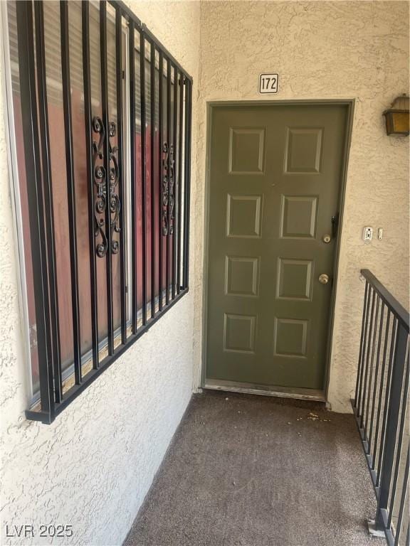 doorway to property with stucco siding