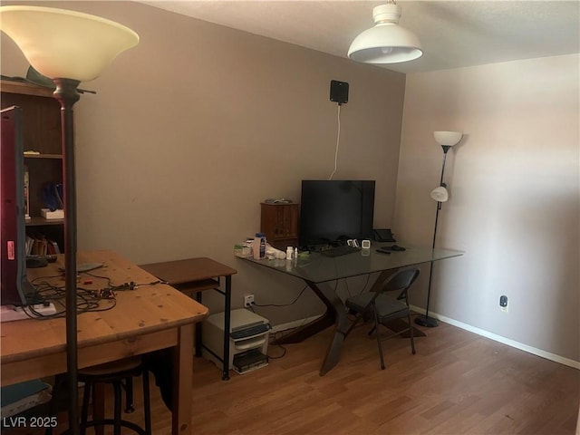 office space with baseboards and wood finished floors