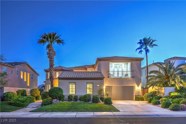 2571 Red Springs Dr, Las Vegas, NV 89135 - mediterranean / spanish home with a garage, a balcony, a tiled roof, concrete driveway, and stucco siding