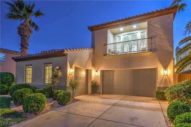2571 Red Springs Dr, Las Vegas, NV 89135 - mediterranean / spanish-style house featuring driveway, stucco siding, a tiled roof, and a balcony