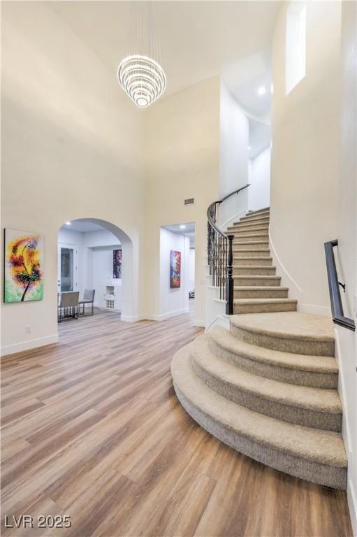 2571 Red Springs Dr, Las Vegas, NV 89135 - entrance foyer with stairway, wood finished floors, baseboards, and arched walkways