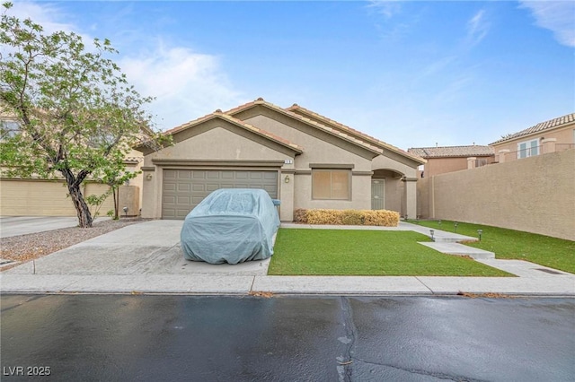 view of front of property with driveway, fence, an attached garage, stucco siding, and a front yard