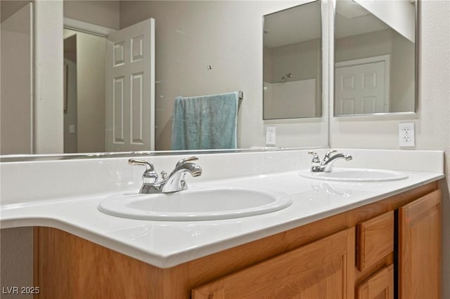 full bathroom with double vanity and a sink