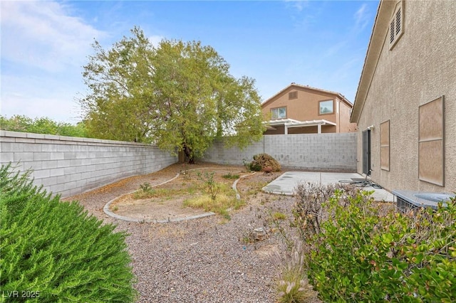view of yard with a patio and a fenced backyard