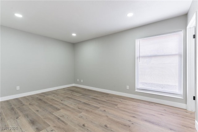 unfurnished room with baseboards, recessed lighting, and light wood-style flooring