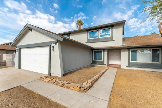 view of front of property featuring stucco siding, roof with shingles, driveway, and an attached garage