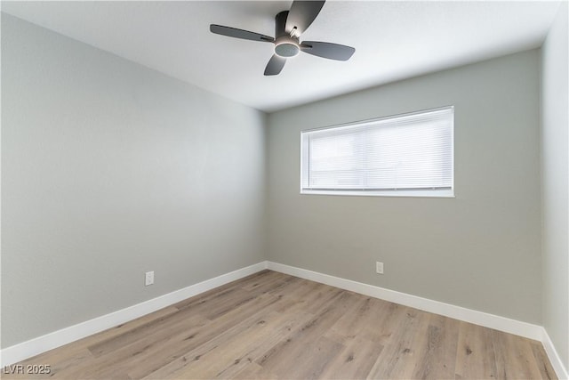 empty room featuring ceiling fan, light wood-type flooring, and baseboards
