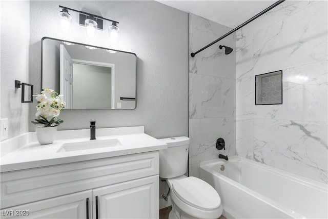 bathroom featuring toilet, a textured wall, bathing tub / shower combination, and vanity