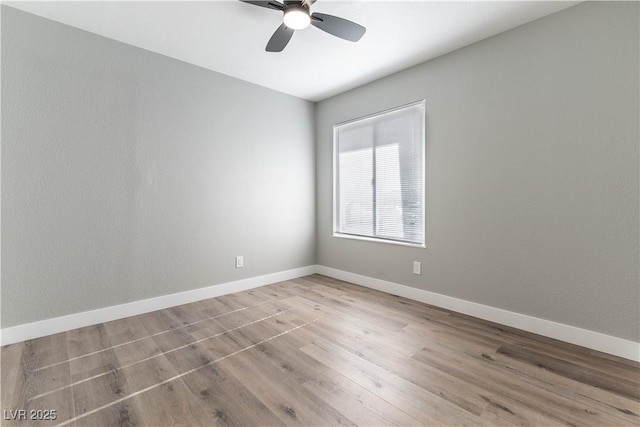 unfurnished room featuring ceiling fan, wood finished floors, and baseboards
