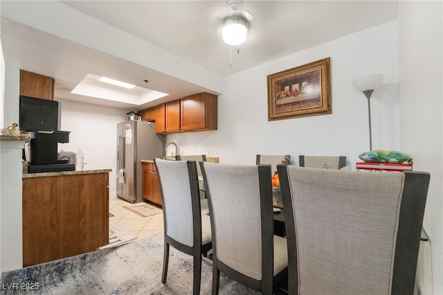 dining room featuring ceiling fan and light tile patterned floors