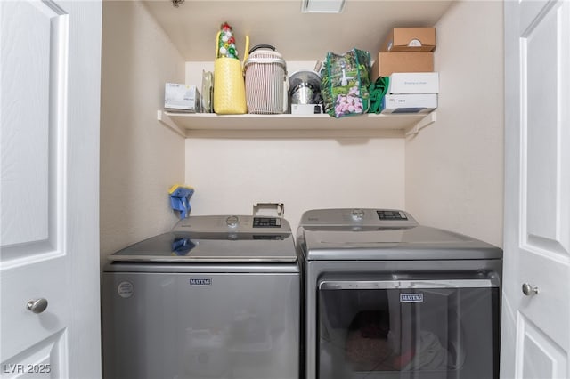 laundry room with separate washer and dryer and laundry area