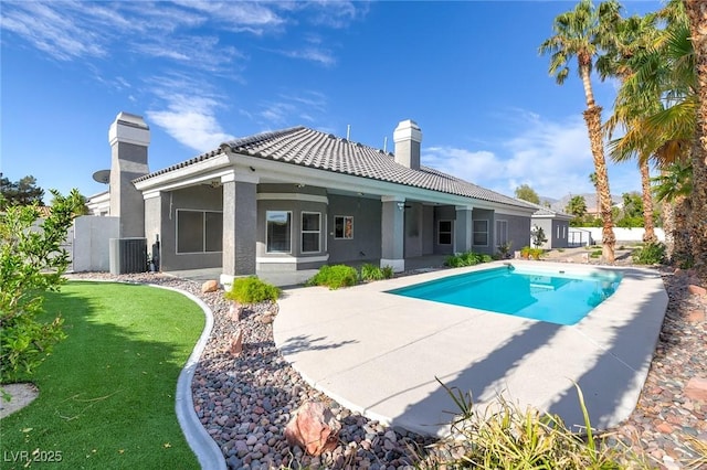 3684 Mooncrest Cir, Las Vegas, NV 89129 - rear view of property featuring a chimney, a tiled roof, stucco siding, and a patio area