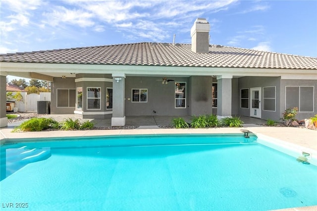 3684 Mooncrest Cir, Las Vegas, NV 89129 - rear view of house featuring a tile roof, a chimney, stucco siding, and an outdoor pool