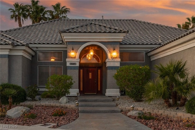 3684 Mooncrest Cir, Las Vegas, NV 89129 - view of exterior entry with a tiled roof and stucco siding