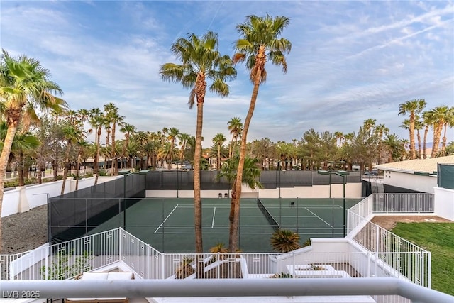 view of tennis court featuring fence