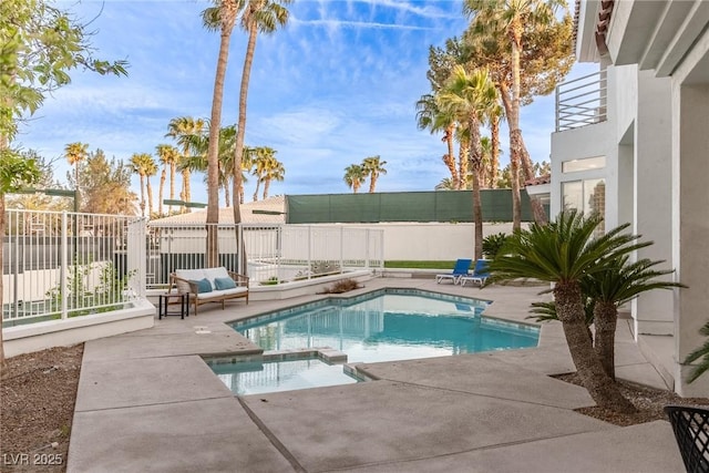 view of pool with a patio, a fenced backyard, and a pool with connected hot tub