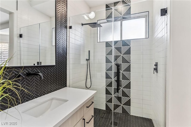 full bath featuring vanity, a stall shower, and tasteful backsplash