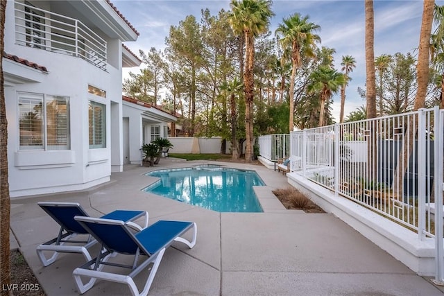 view of swimming pool featuring a fenced in pool, a fenced backyard, and a patio area