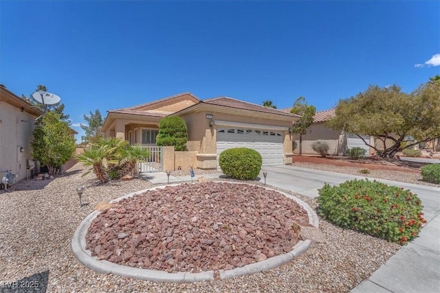 view of front of house with fence, an attached garage, driveway, and stucco siding
