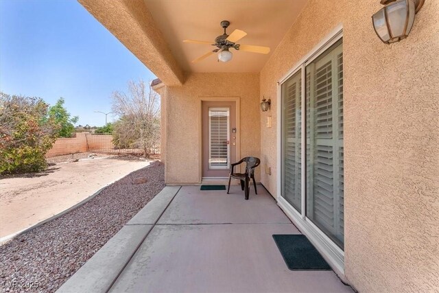 view of patio / terrace with fence and ceiling fan