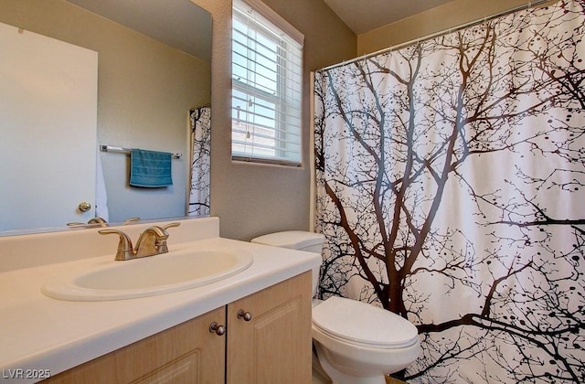 bathroom with toilet, curtained shower, and vanity