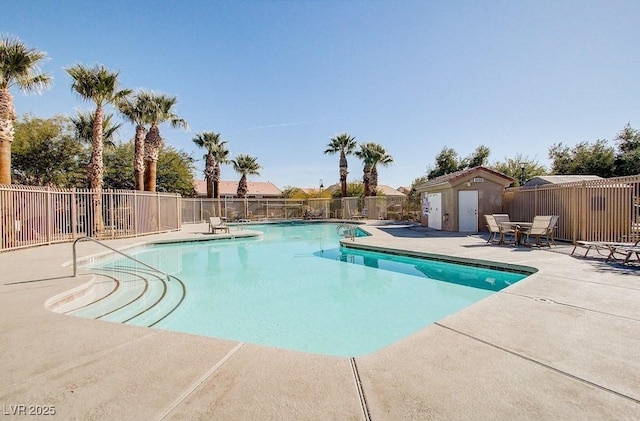 community pool featuring a patio and fence