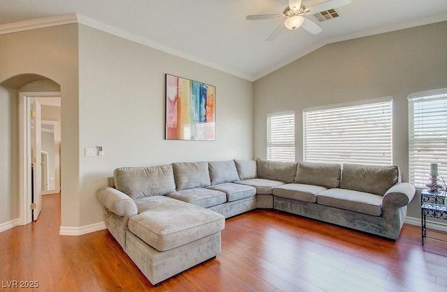 living area featuring arched walkways, ceiling fan, a wealth of natural light, and lofted ceiling