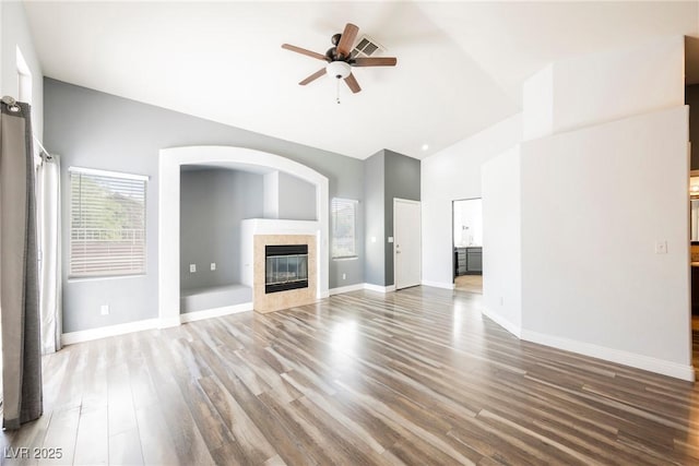 10404 Shadowland Ave, Las Vegas, NV 89144 - unfurnished living room featuring high vaulted ceiling, ceiling fan, wood finished floors, baseboards, and a fireplace