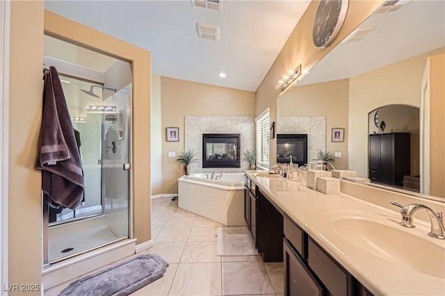 bathroom featuring double vanity, a shower stall, a bath, and a sink
