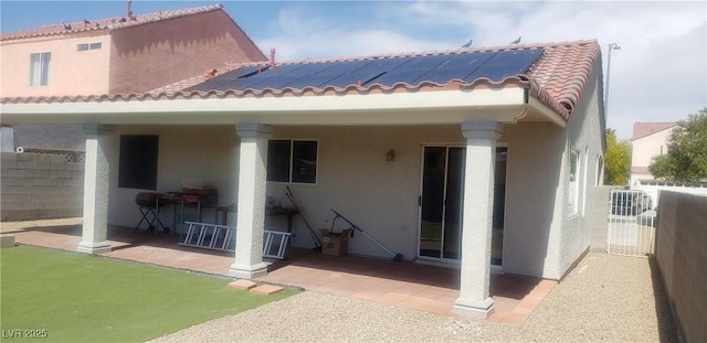 857 Lantham Pl, Las Vegas, NV 89110 - rear view of house featuring solar panels, stucco siding, a patio, and a tile roof