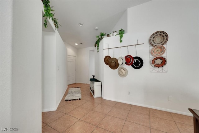 hall with light tile patterned floors, recessed lighting, and baseboards