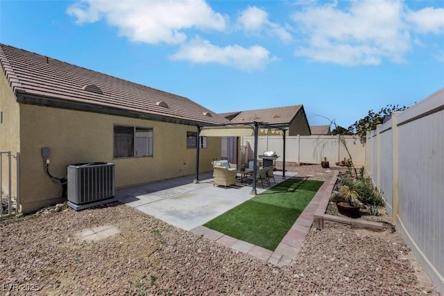 back of property with a fenced backyard, stucco siding, a tile roof, a patio area, and cooling unit