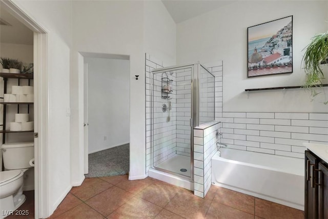 bathroom featuring tile patterned floors, toilet, a shower stall, and a bath