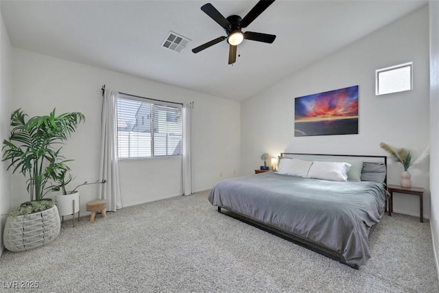 bedroom with carpet flooring, a ceiling fan, visible vents, and vaulted ceiling