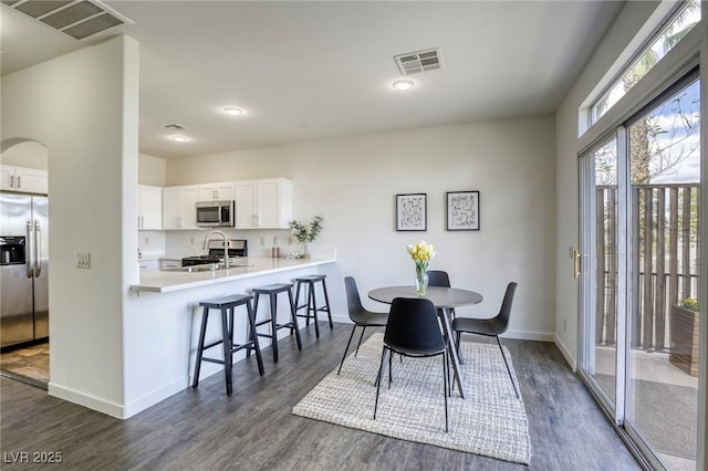 9966 Mystic Moss St, Las Vegas, NV 89183 - dining area featuring baseboards, visible vents, and dark wood-style flooring