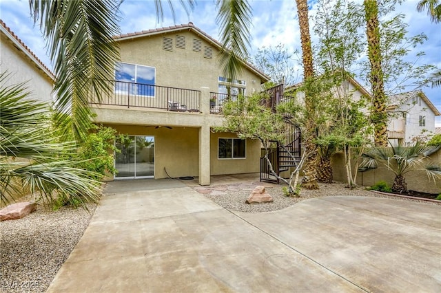 9966 Mystic Moss St, Las Vegas, NV 89183 - rear view of property with stairway, stucco siding, a balcony, and a patio area